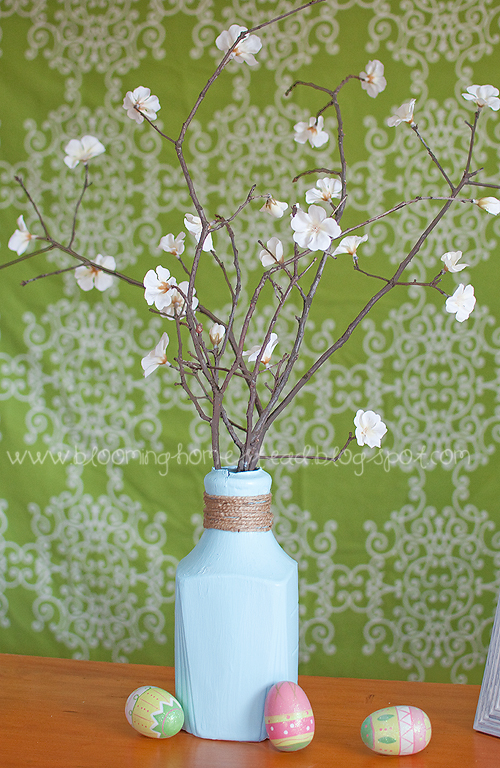 Easy spring centerpiece using an uncycled orange juice bottle! So pretty!