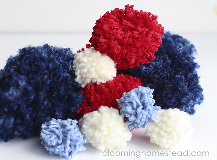 DIY Pom Pom Garland for 4th of July Decor. These are so cute and so easy to make!