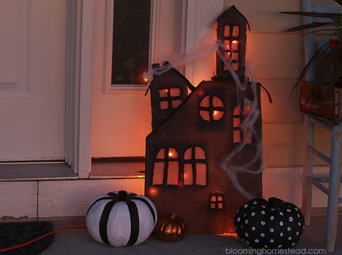 This diy lighted haunted house is so simple and easy to make, be sure to check out the full tutorial on www.bloominghomestead.com