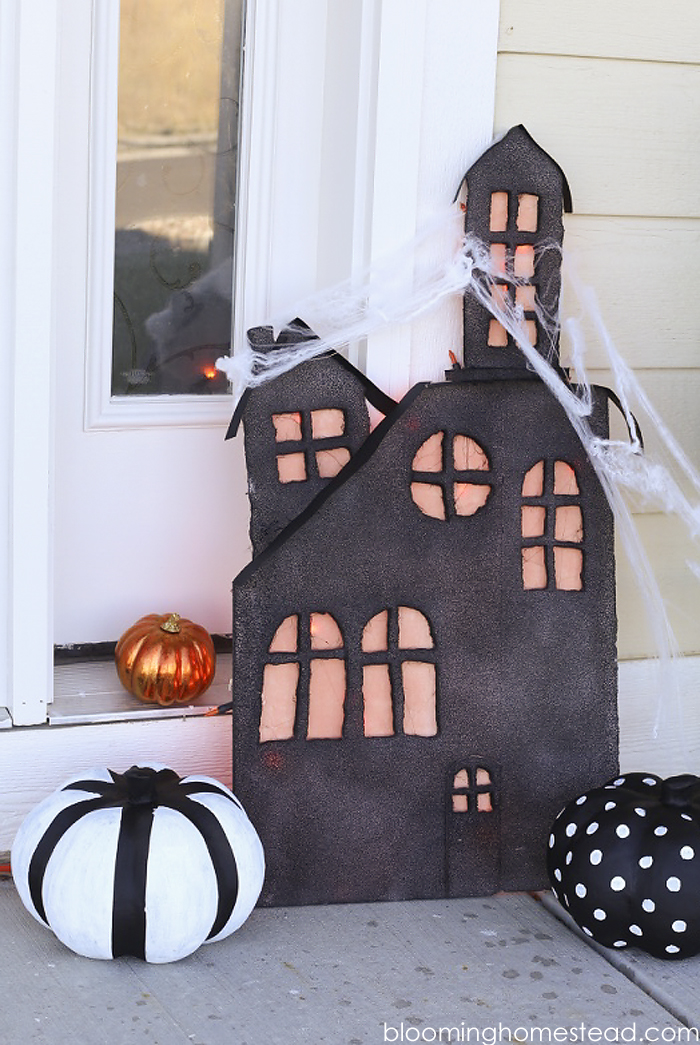 This diy lighted haunted house is so simple and easy to make, be sure to check out the full tutorial on www.bloominghomestead.com