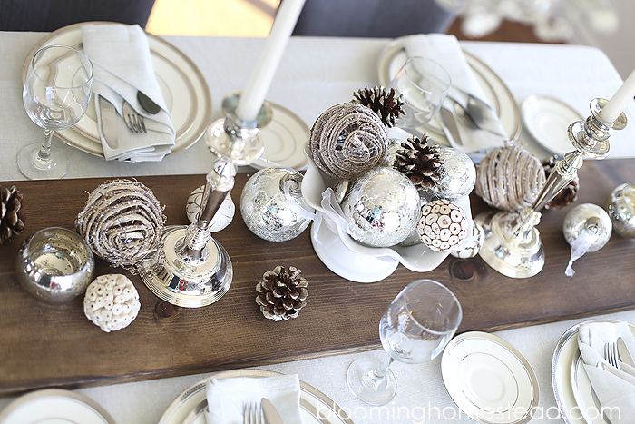 Beautiful winter tablescape featuring a metallic feel with rustic elements. Wouldn't this be a perfect Christmas Tablescape or for any holiday?