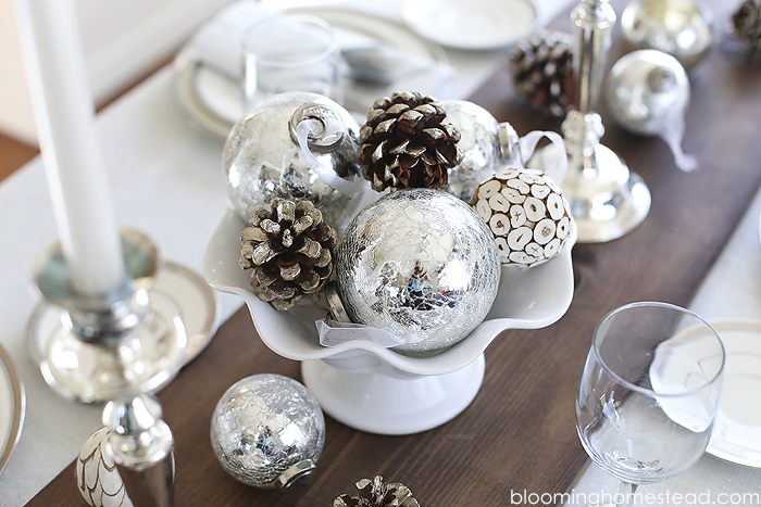 Beautiful winter tablescape featuring a metallic feel with rustic elements. Wouldn't this be a perfect Christmas Tablescape or for any holiday?