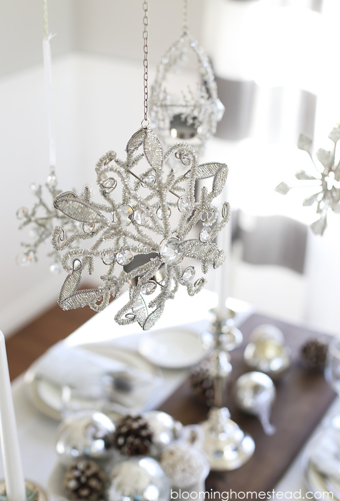 Beautiful winter decor for holiday entertaining. Love these hanging snowflakes!