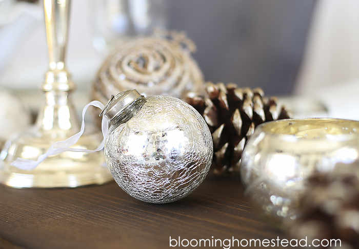 Beautiful winter tablescape featuring a metallic feel with rustic elements. Wouldn't this be a perfect Christmas Tablescape or for any holiday?